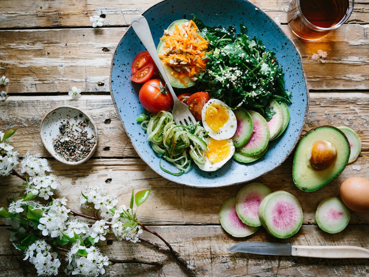 Fresh, colorful whole-food meal laid out on a rustic wooden table